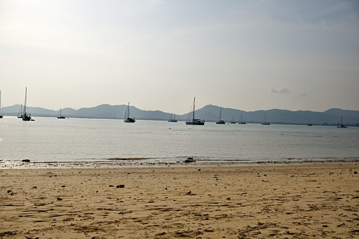 Local beach near Phuket Town with yachts on the horizon